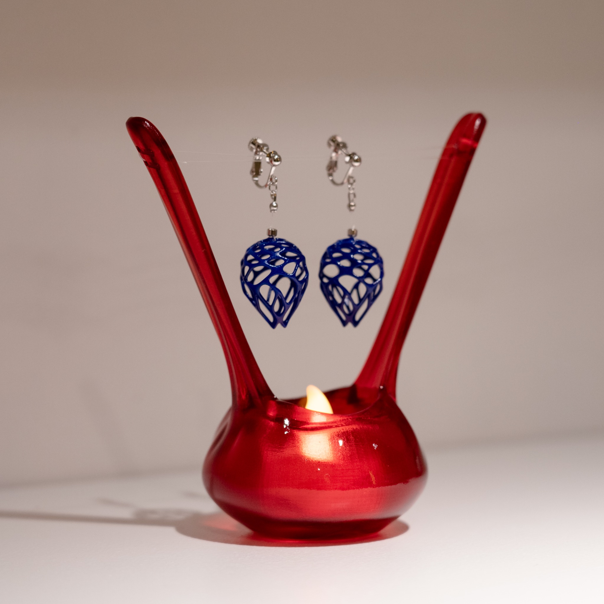 red display object with blue earrings